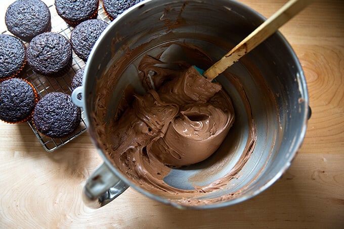 A bowl of chocolate buttercream frosting.