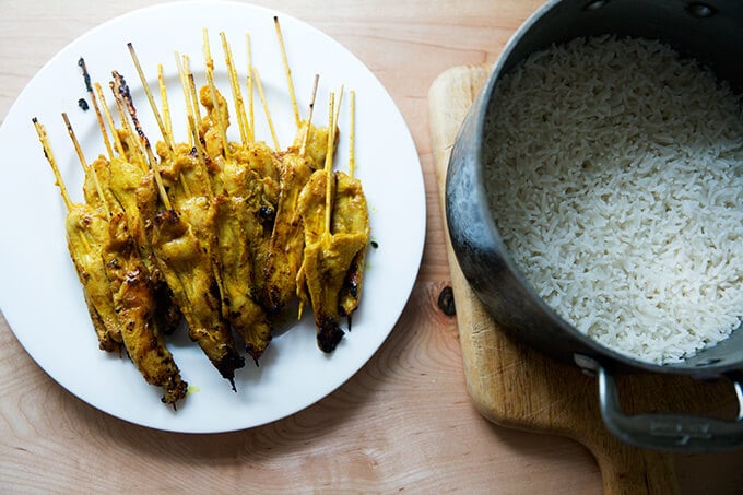 A plate of easy Thai chicken satay aside a pot of coconut rice.
