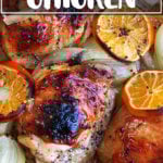 A Roasting pan filled with roast chicken and clementines.