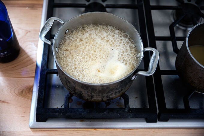 A saucepan filled with gravy simmering.