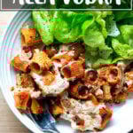 A bowl of just-baked penne alla vodka aside salad.