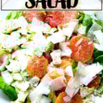 A platter topped with an endive, grapefruit and avocado salad, finished with shavings of parmesan.