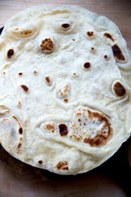 An overhead shot of a stack of homemade flour tortillas.