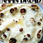 A stack of homemade, yeasted naan on a plate.