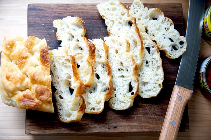 Sliced stale focaccia on a board.