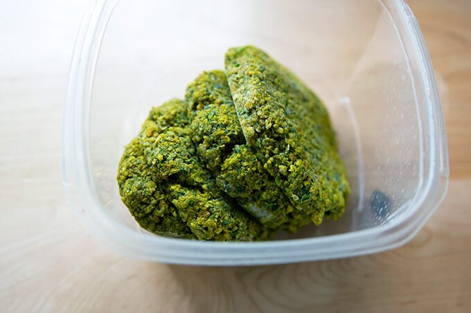 Frozen falafel burgers in a container.