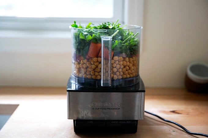 Ingredients for falafel burger in a food processor.
