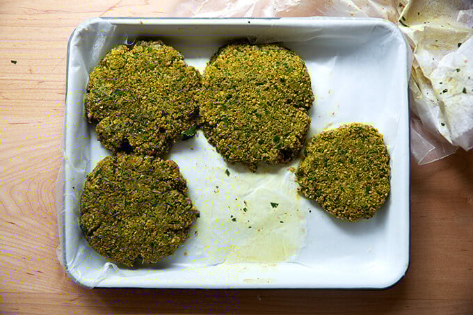 Frozen falafel burgers on a tray.