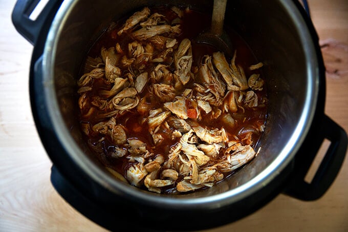 An Instant Pot filled with just-cooked chicken tinga.