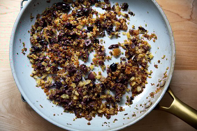 Olive bread crumbs in a skillet.