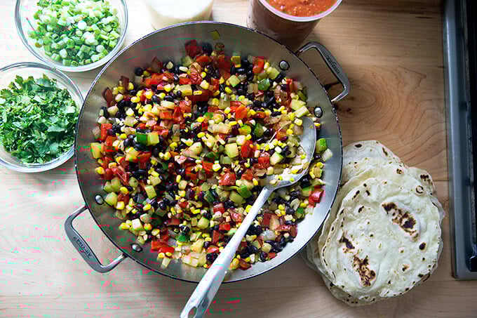 Ingredients on a counter top for the summer vegetable enchilada casserole.