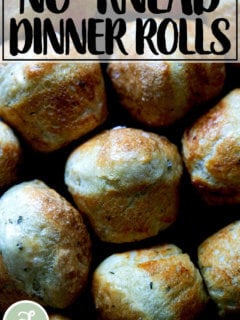 Thyme dinner rolls on a board.