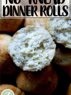 A halved and buttered thyme dinner roll.