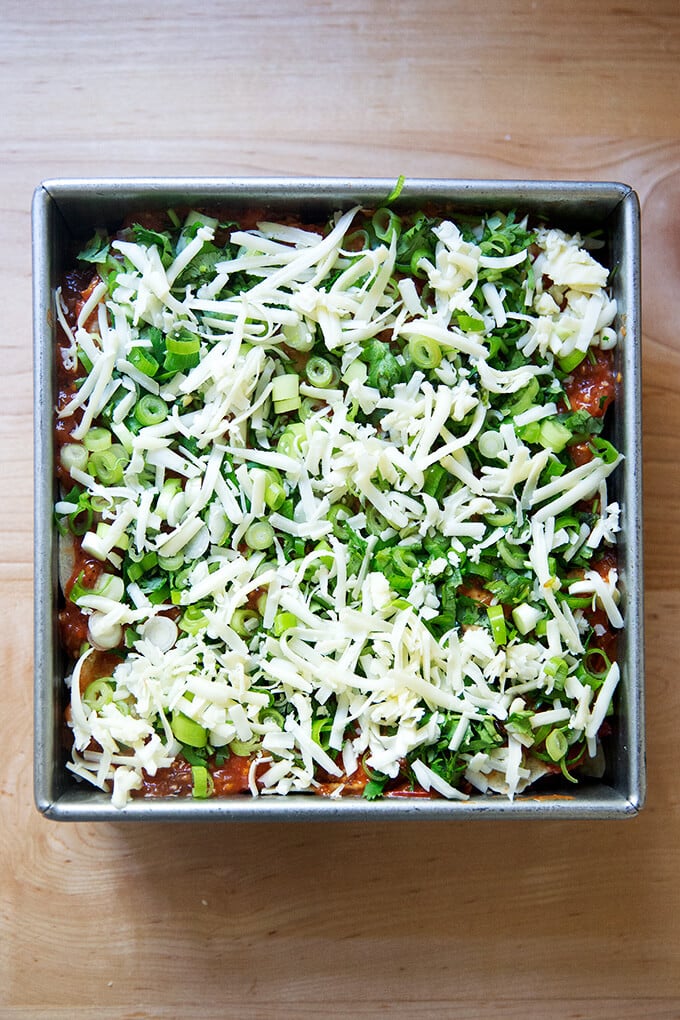 An unbaked vegetarian tortilla casserole.