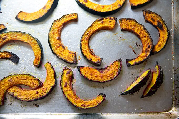 Roasted kabocha squash on a sheet pan.