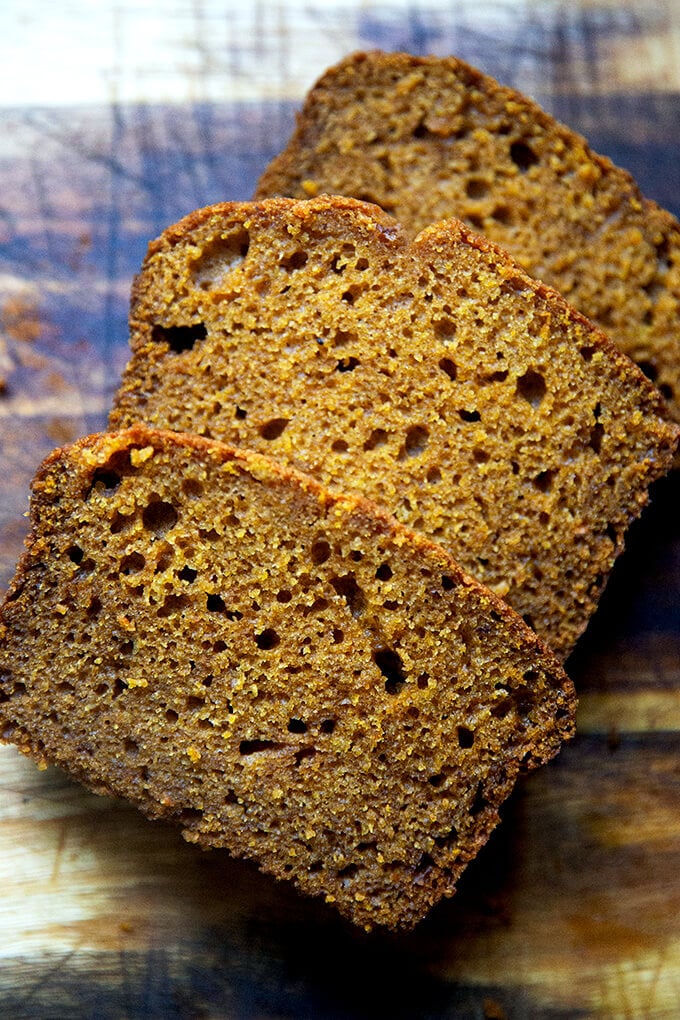 Sliced pumpkin bread on a board.