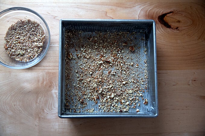 A 9-inch pan, buttere, and sprinkled with ground pecans.