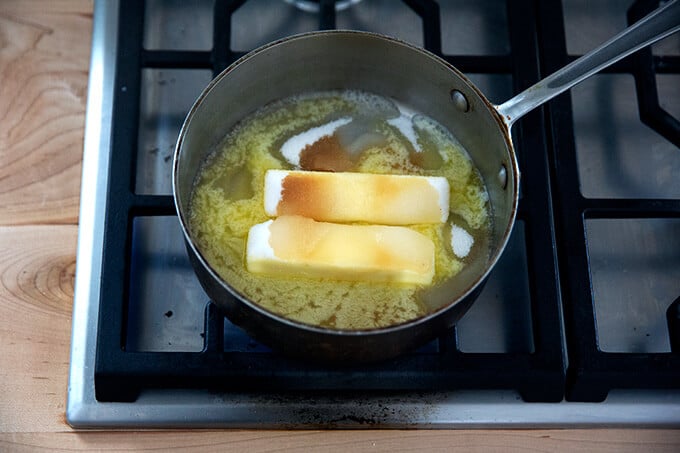Butter, sugar, water, and vanilla simmering stovetop.