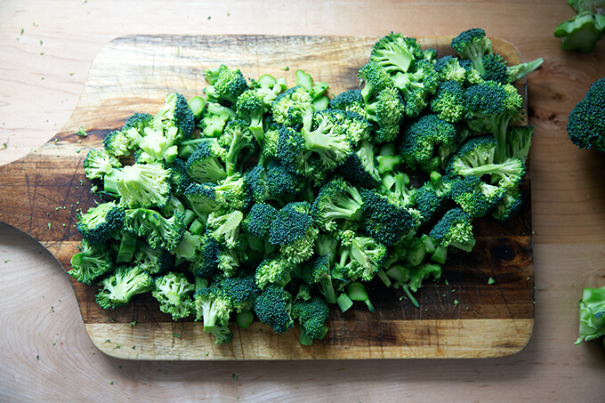 Chopped broccoli on a cutting board.