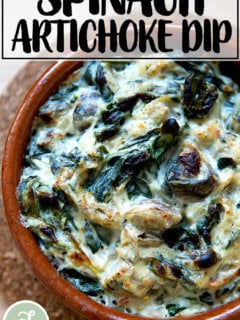A small dish filled with spinach-artichoke dip just broiled.