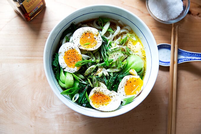 A bowl of life changing udon noodles with bok choy and soft boiled eggs. 