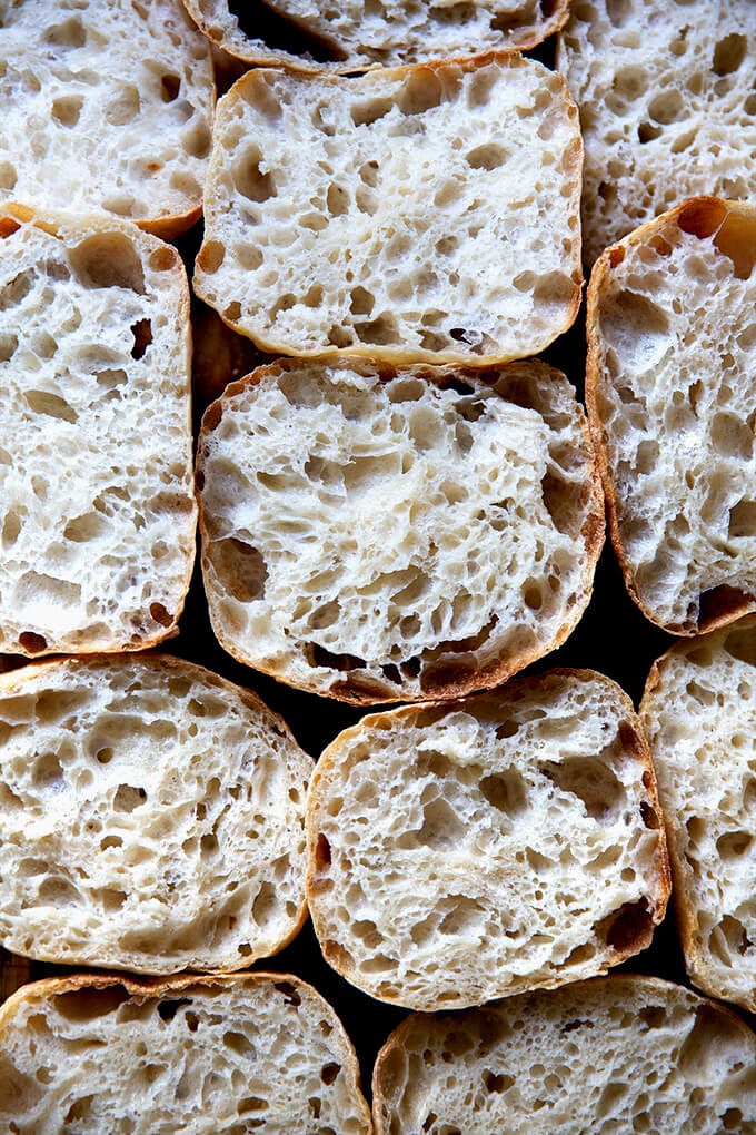 Halved sourdough ciabatta rolls on a countertop.