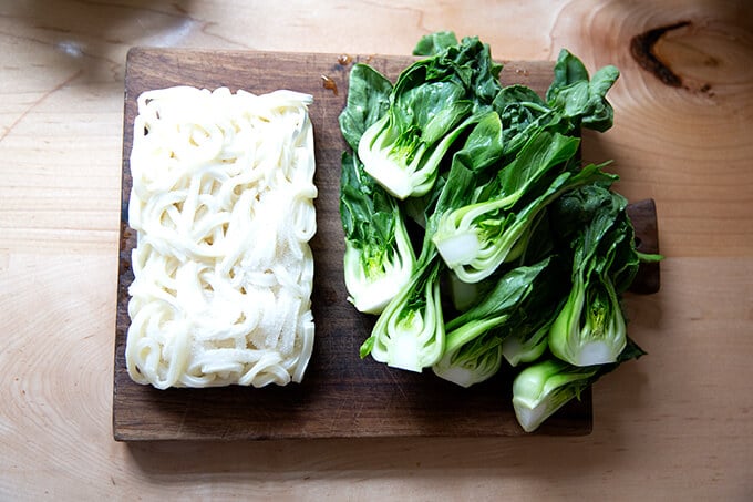 Frozen udon noodles aside baby bok choy.