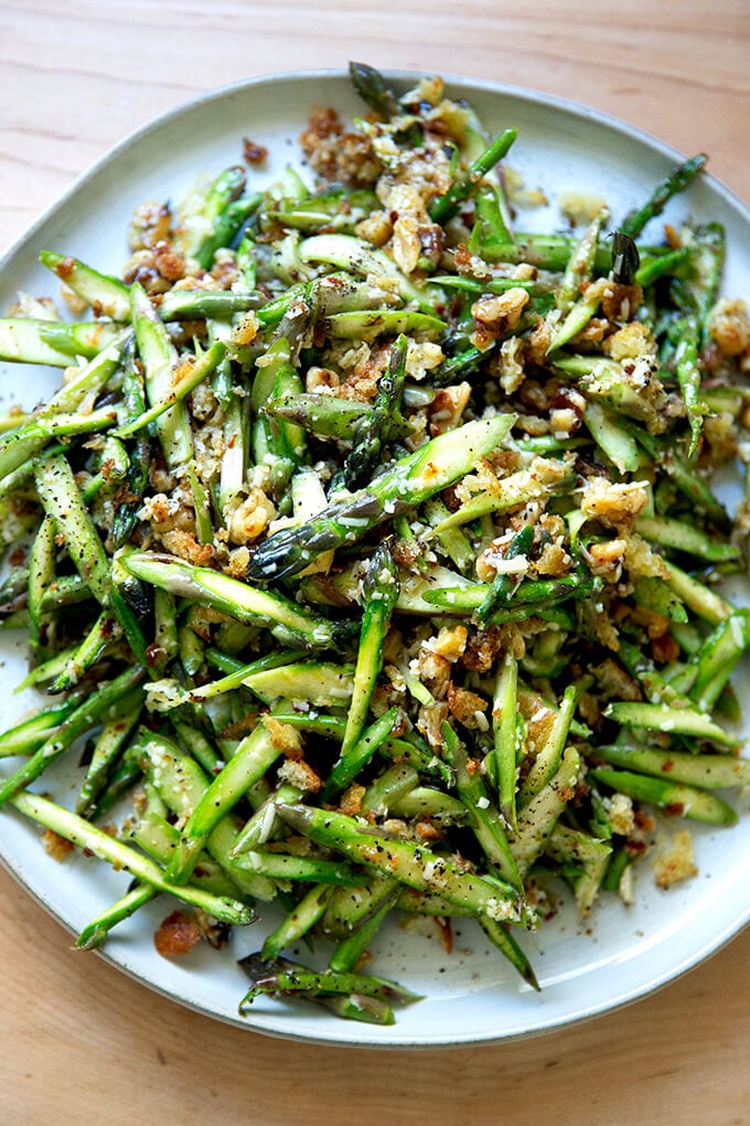 A raw asparagus salad on a platter.