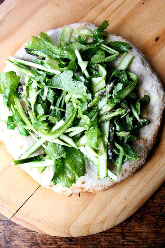 This shaved asparagus arugula salad makes a lovely side dish on its own, but can easily be turned into a filling and delicious meal: Simply heap it atop an enormous carbohydrate—pizza, flatbread, bruschetta. There’s no science behind that. // alexandracooks.com