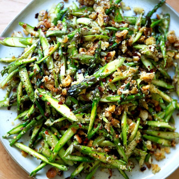 A raw asparagus salad on a platter.