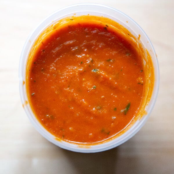An overhead shot of homemade tomato sauce in a quart container.
