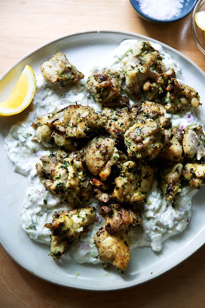 Chicken souvlaki on a plate with tzatziki.