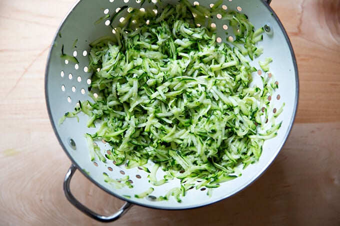 Grated zucchini in a colander.