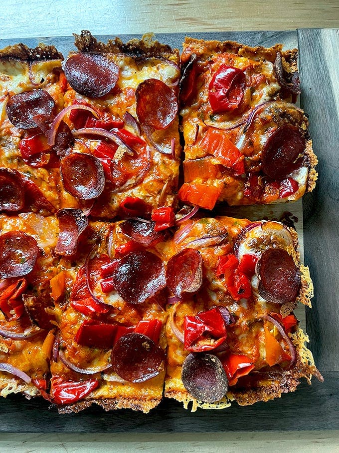 Detroit-style pizza, cut into squares on a board. 