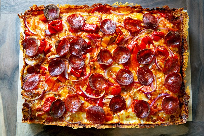 A just-baked Detroit-style pizza on a board. 