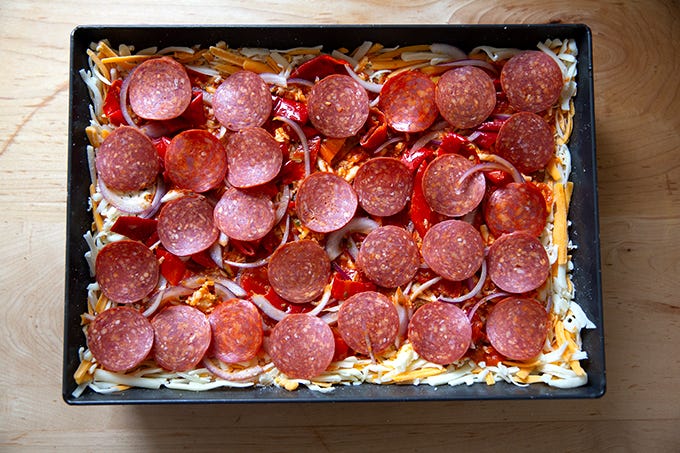 An unbaked Detroit-style pizza, ready for the oven. 