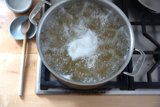 A pot of pasta boiling on the stovetop.