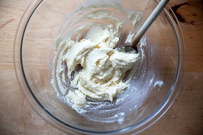 A bowl of butter and sugar mixed together.