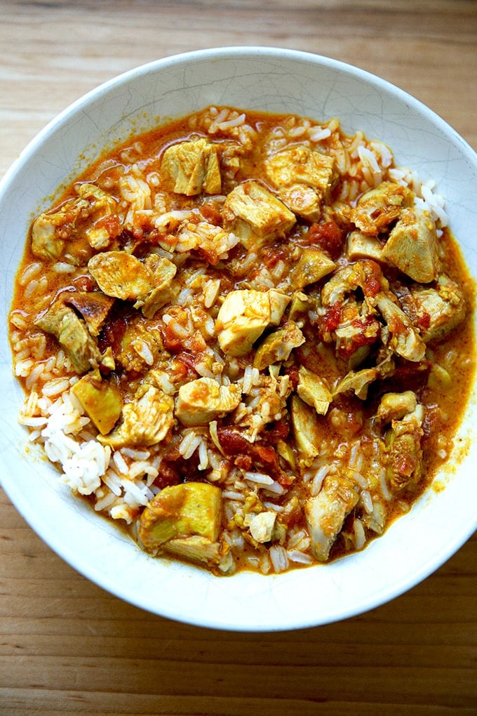 A bowl of butter chicken and rice.