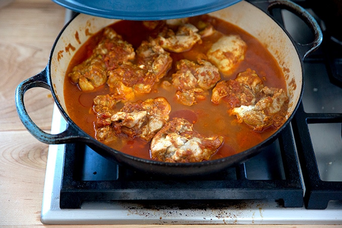 A large braiser filled with cooked butter chicken.