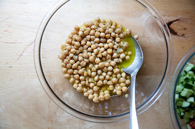 A large bowl filled with chickpeas tossed in a lemon vinaigrette.