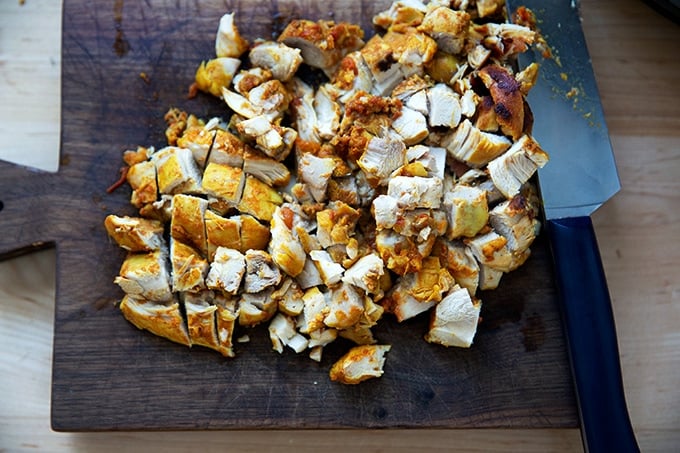 Cooked butter chicken on a board.