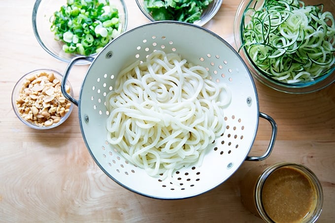 Components for a peanut noodle salad on a countertop.