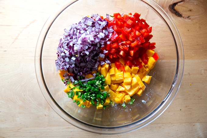 The ingredients to make mango salsa in a large bowl.