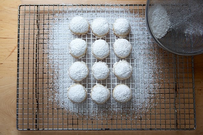 Lemon-almond snowball cookies cooling on a cooling rack.