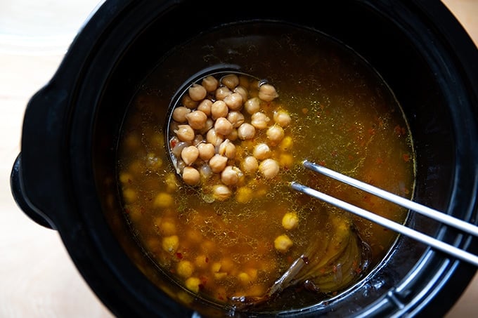 A crockpot holding just-cooked chickpeas.