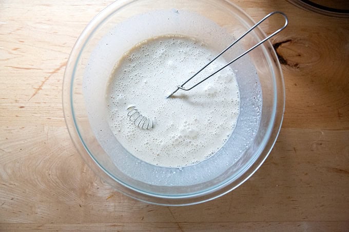 The cream, eggs, sugar and spices for butternut squash pie all whisked together.