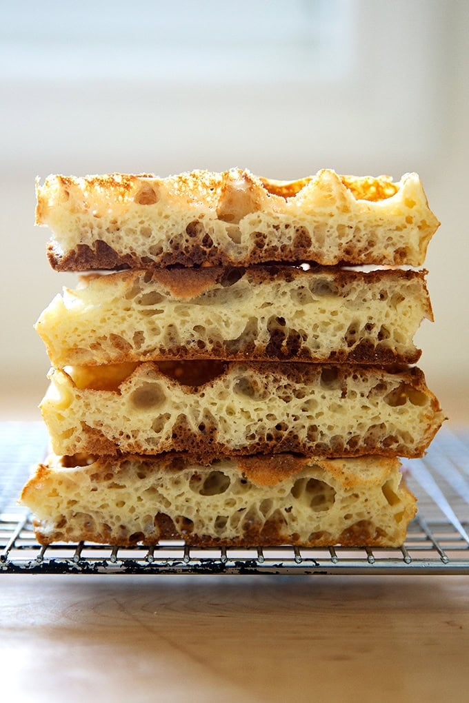 A stack of halved sourdough discard waffles, revealing an open crumb.