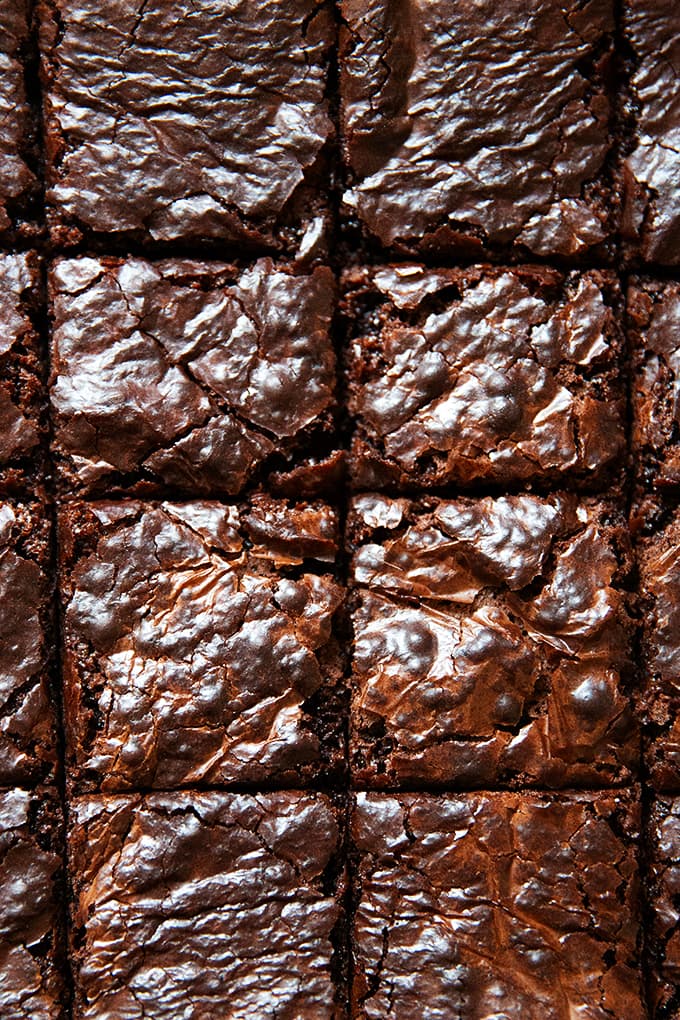 An up close photo of cut brownies on a board.