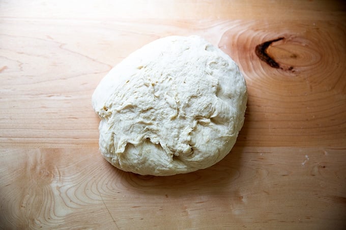 Soft pretzel dough turned out onto a countertop.